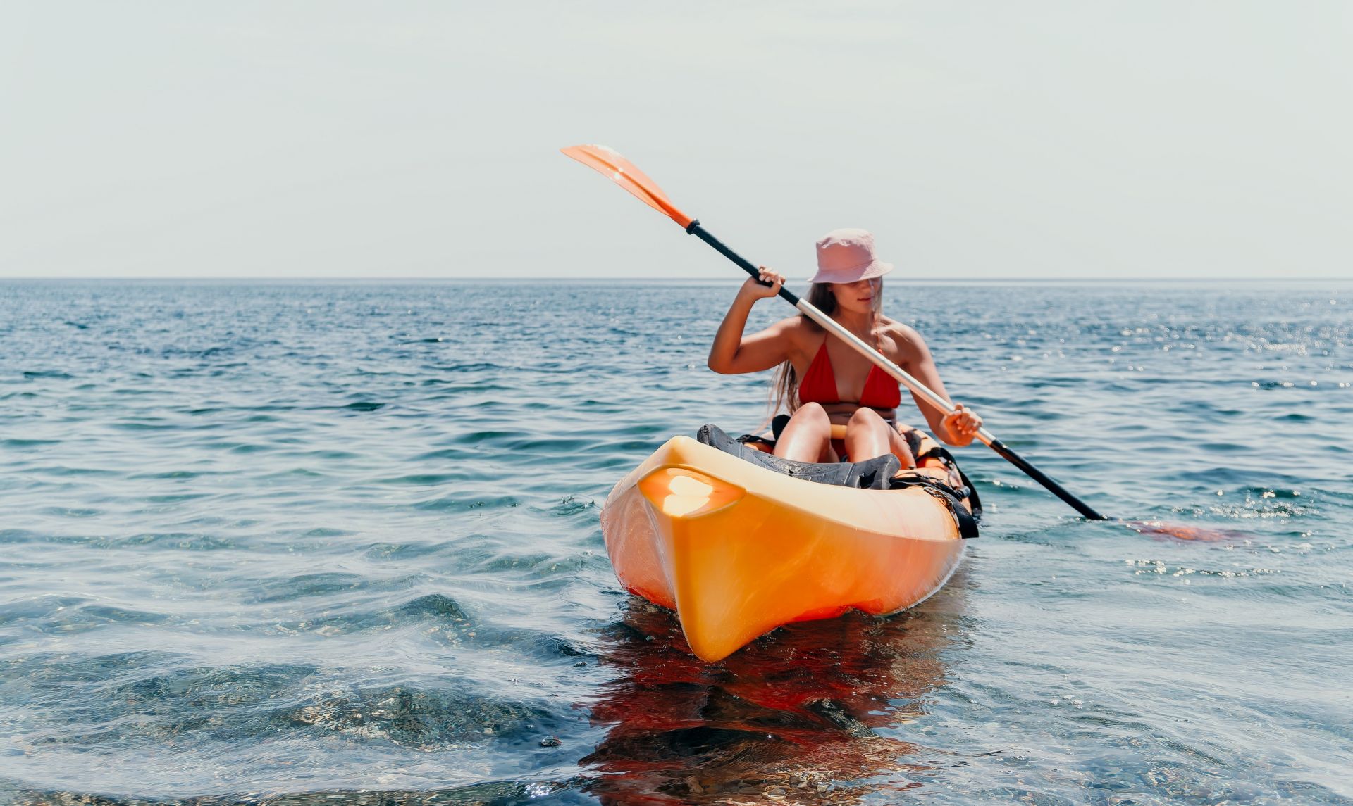 Woman kayaking on the ocean